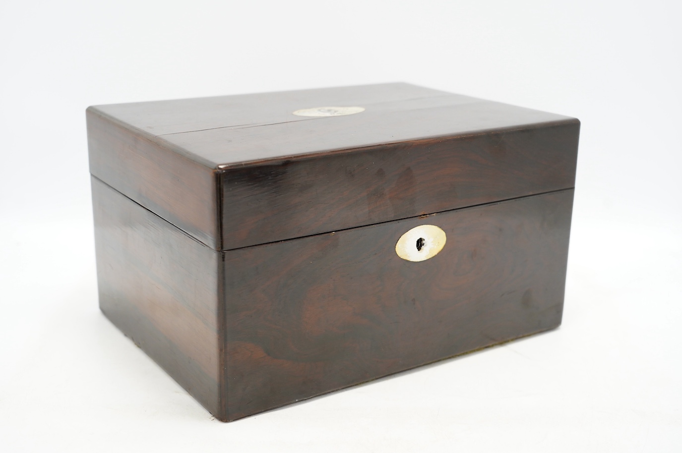 A Victorian rosewood toilet box with silver plate lidded bottles, ‘secret’ draw and leather case, 30cm wide. Condition - fair